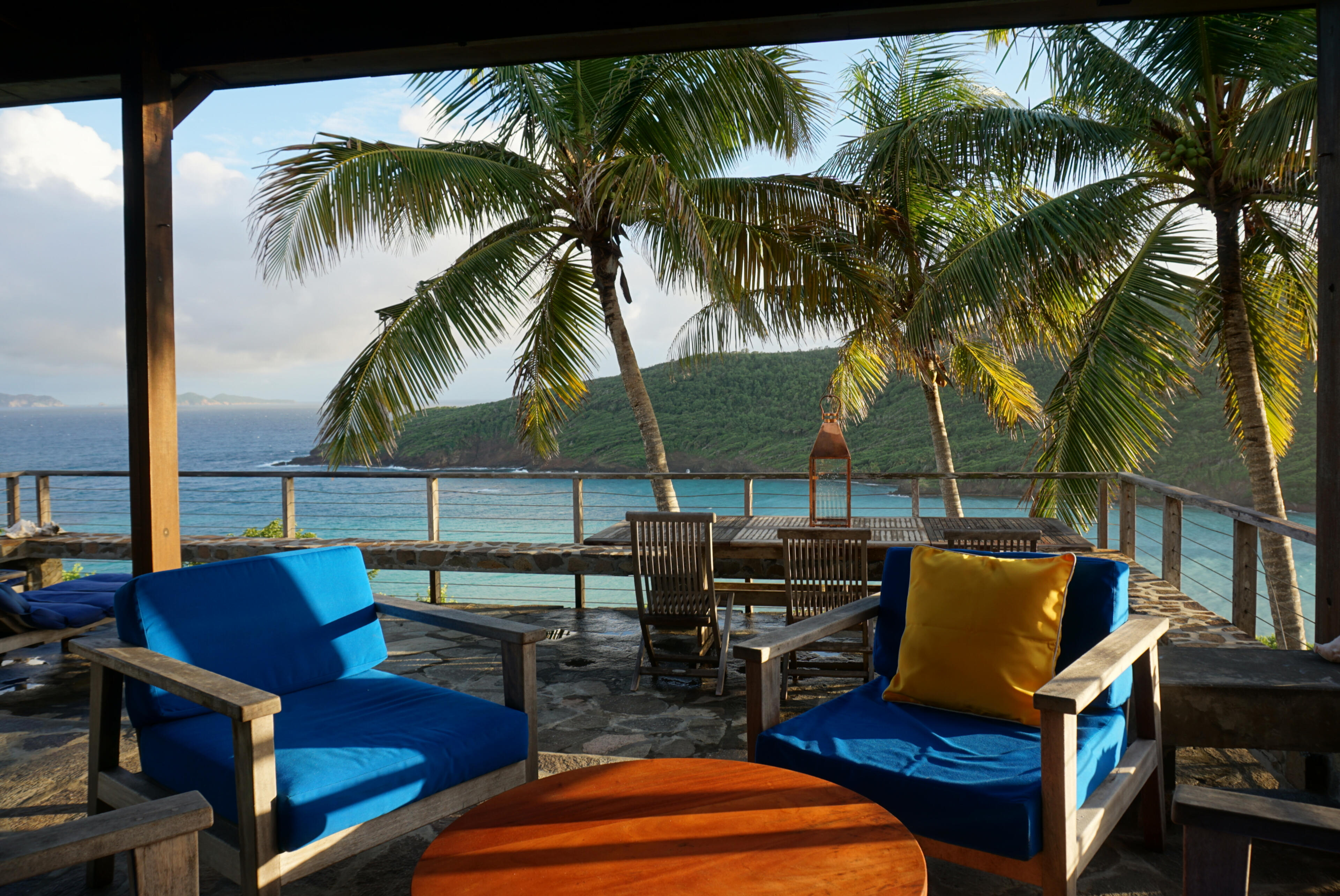 Seating on the Deck Seating area on the deck with palm trees and water view